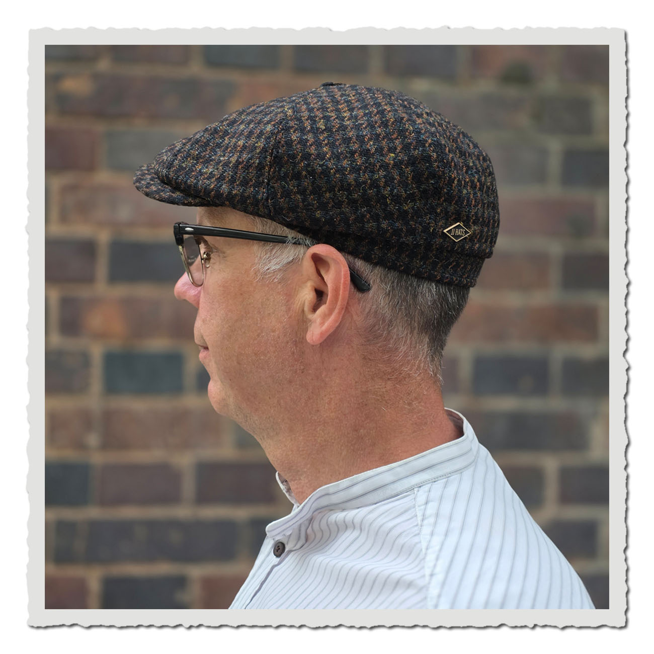 Seitenansicht der Ballonmütze von JJ Hats im klassischem Harris Tweed. Die Ballonmütze ist in traditioneller 8-Panel-Form gefertigt. Die Mütze ist aus robustem Tweed mit kleinem Karomuster in dunklen Braun- und Grüntönen gefertigt und trägt seitlich ein d